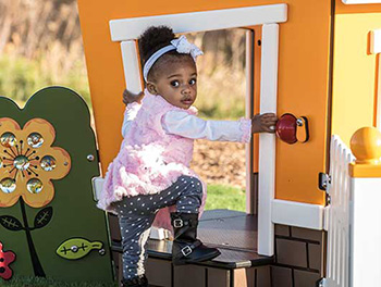 Girl playing in Smart Play Nook playhouse