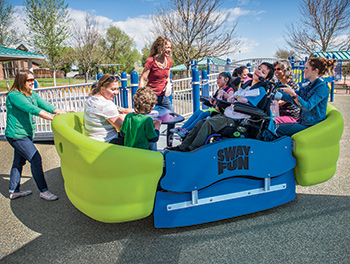Adults and children playing on a Sway Fun glider